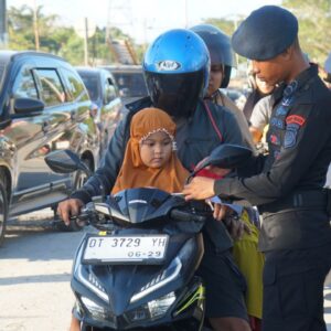 Semarak Merah Putih: Brimob Polda Sultra Bagikan dan Pasangkan Bendera kepada Pengguna Jalan Sambut HUT RI ke-80