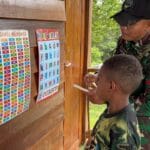 Implementasi Program Calistung oleh TNI Untuk Mendukung Pembangunan SDM di Kampung Kombut